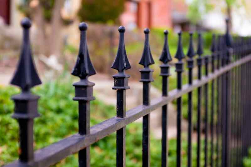 Close-up of black aluminum fence finials